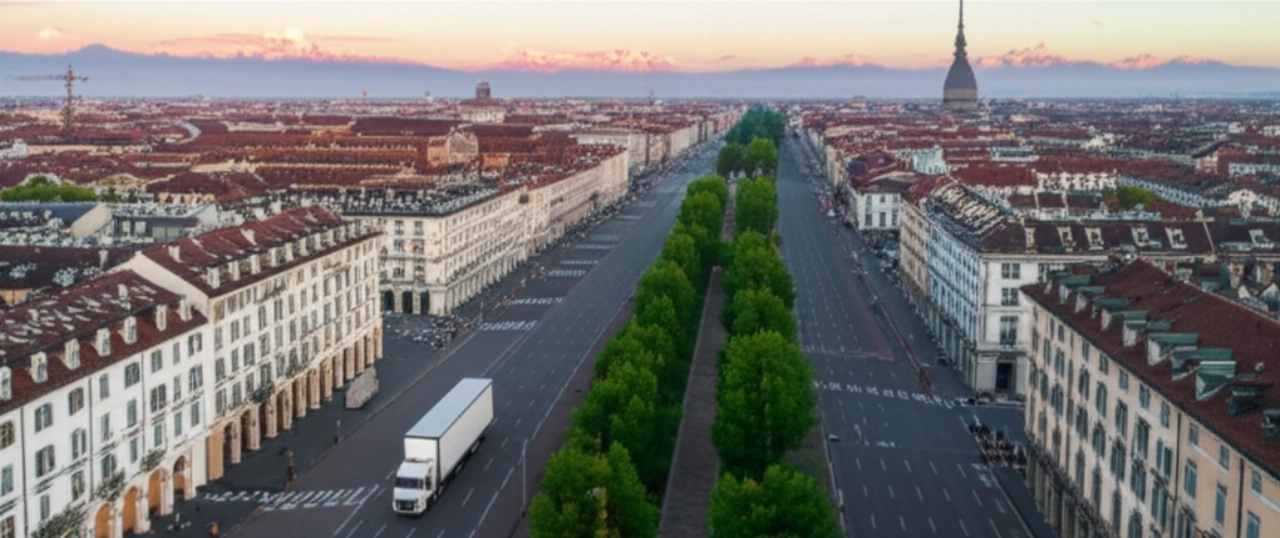 Vista aerea mozzafiato di Torino all'alba con le Alpi sullo sfondo e un furgone di traslochi che attraversa la città, evidenziando la portata del servizio di trasloco.